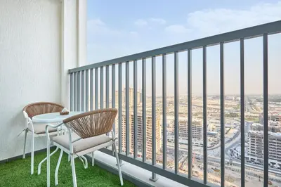 a balcony with two chairs and a table with a view at STAY BY LATINEM Luxury 1BR Holiday Home CB 2601 Near Burj Khalifa in Dubai