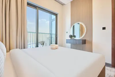 a bedroom with a large bed and a large window at STAY BY LATINEM Luxury 1BR Holiday Home CB 2601 Near Burj Khalifa in Dubai