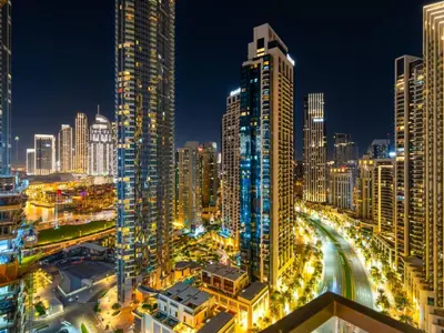 a city skyline at night with many tall buildings at Vogue Downtown Burj Crown near Burj Khalifa and Dubai Mall, Three Bedroom plus Kids Room Apartment with Large Balcony and Skyline view, Access to all Amenities in Dubai