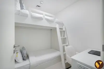 a bedroom with a bunk bed with a ladder and a desk at Vogue Downtown Burj Crown near Burj Khalifa and Dubai Mall, Three Bedroom plus Kids Room Apartment with Large Balcony and Skyline view, Access to all Amenities in Dubai