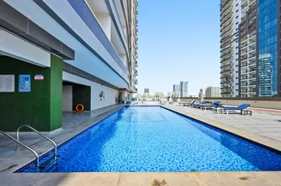 a swimming pool on the roof of a building at Modern Luxury 2BR Apartment In Dubai Sports City in Dubai