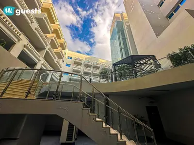 a building with a staircase in front of a building at HiGuests - Experience Luxury 1BR Living at Autumn-1A in JVC in Dubai