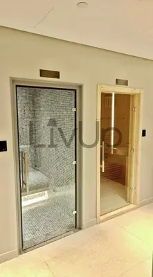 a glass door with a chicken inside of a room at Stylish New Studio Apartment with Balcony in Dubai
