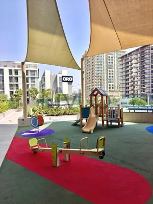 a play area with a playground with a slide at Stylish New Studio Apartment with Balcony in Dubai