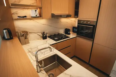 a kitchen with a sink and a stove at Stylish 1-Bedroom in JVC with large balcony in Dubai
