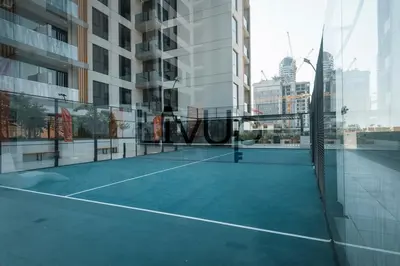 a tennis court in the middle of a building at Stylish 1-Bedroom in JVC with large balcony in Dubai