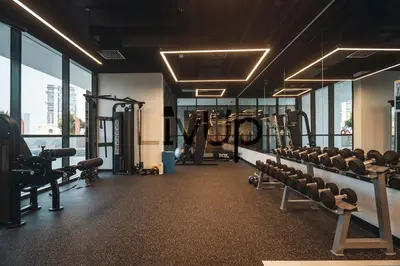 a gym with a lot of treadmills and machines at Stylish 1-Bedroom in JVC with large balcony in Dubai