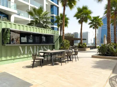 a patio with a table and chairs in front of a building at GuestReady - Studio l Canal Views | Business Bay in Dubai
