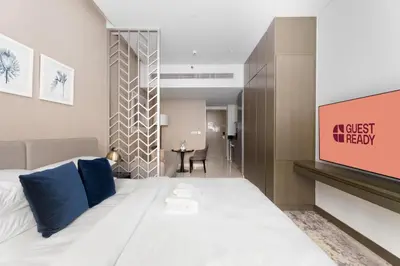 a hotel room with a bed and a tv at GuestReady - Studio l Canal Views | Business Bay in Dubai