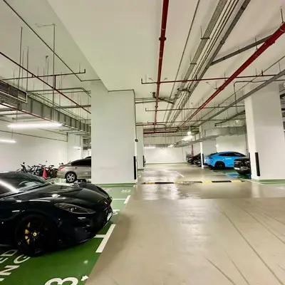 a parking garage with cars parked in it at Boulevard Heights Downtown Perfect Location High floor Luxury Apartment! in Dubai