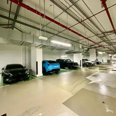 a parking garage with several cars parked in it at Boulevard Heights Downtown Perfect Location High floor Luxury Apartment! in Dubai