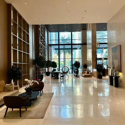 a large lobby with tables and chairs in a building at Boulevard Heights Downtown Perfect Location High floor Luxury Apartment! in Dubai