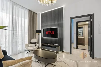 a living room with a tv on a wall at Burj Khalif View from Bedroom - Millionaire Residence in Business Bay Dubai in Dubai