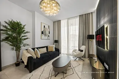 a living room with a black couch and a table at Burj Khalif View from Bedroom - Millionaire Residence in Business Bay Dubai in Dubai
