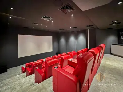 a cinema room with red chairs and a screen at Burj Khalif View from Bedroom - Millionaire Residence in Business Bay Dubai in Dubai
