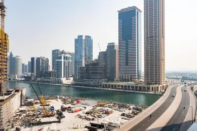 a view of a city with a river and buildings at GuestReady - 1BR l Canal View | Business Bay in Dubai