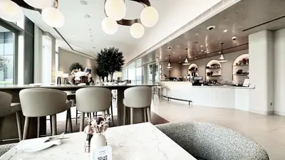 a restaurant with a bar with chairs and a counter at Vida Residence Dubai Mall by Propigo in Dubai