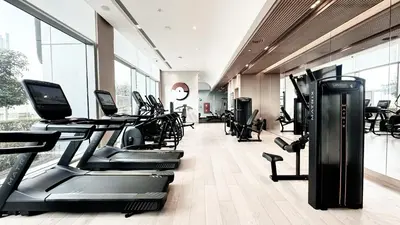 a gym with treadmills and elliptical machines at Vida Residence Dubai Mall by Propigo in Dubai