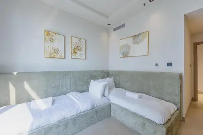 a bed with two pillows on it in a room at Skyview Luxe 4BR - Elegant Sea & Ain Dubai View in Dubai