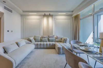 a living room with a couch and a table at Skyview Luxe 4BR - Elegant Sea & Ain Dubai View in Dubai