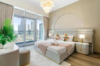 a bedroom with a large bed and a large window at Classy and Chic 2BR in Downtown with Burj Khalifa View in Dubai