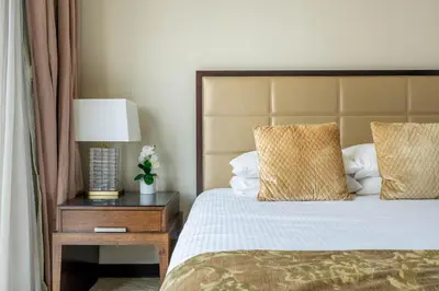 a bedroom with a bed and a table with a lamp at Marina Views & 5-Star Comfort Dubai Marina in Dubai