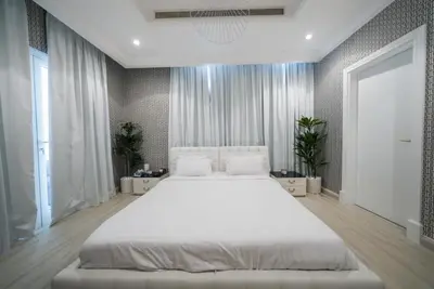 a large bedroom with a large white bed in it at World Class Luxurious 5 BDR Villa In Palm Jumeriah in Dubai