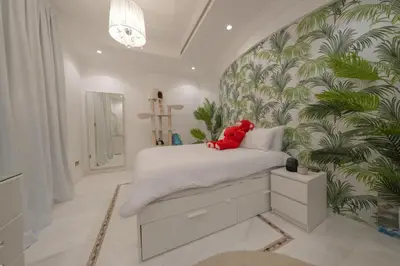 a bedroom with a bed with a teddy bear on it at World Class Luxurious 5 BDR Villa In Palm Jumeriah in Dubai