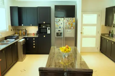 a kitchen with a table with a bowl of fruit on it at World Class Luxurious 5 BDR Villa In Palm Jumeriah in Dubai