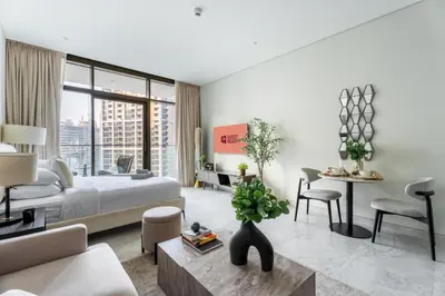 a bedroom with a bed and a living room at GuestReady - Studio | Canal View & Burj Khalifa in Dubai