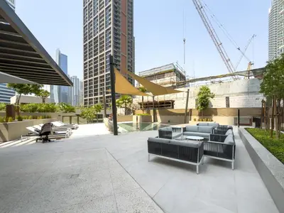 a patio with chairs and tables in a city at GuestReady - Studio | Canal View & Burj Khalifa in Dubai