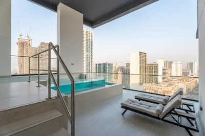 a living room with a balcony with a view of a city at GuestReady - Luxury with a Private Pool | 2 BHK in Dubai