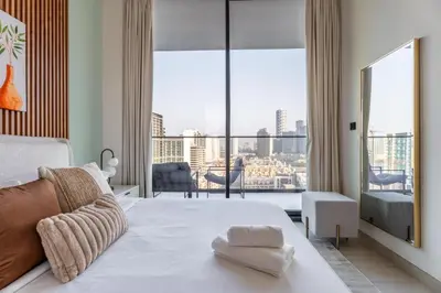 a bedroom with a large bed and a large window at GuestReady - Luxury with a Private Pool | 2 BHK in Dubai