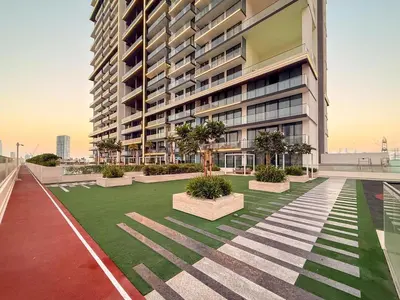 a large building with a lawn in front of it at GuestReady - Luxury with a Private Pool | 2 BHK in Dubai