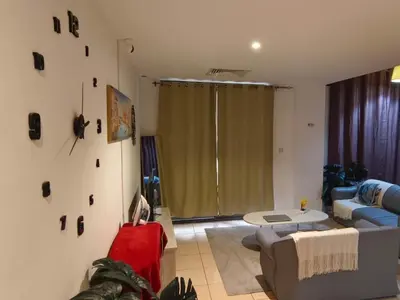 a living room with a couch and a table at Dubai Beach Living JBR Hostel in Dubai