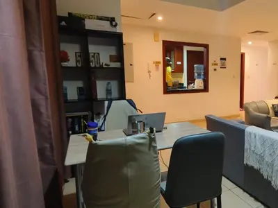 a table and chairs with a laptop computer on it at Dubai Beach Living JBR Hostel in Dubai