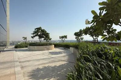 a skateboard park with trees and plants on a sidewalk at Cozy 2BR Aykon City Near Downtown - Pool and Gym in Dubai