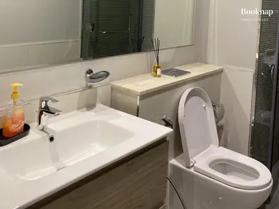 a white bathroom with a sink and a toilet at Luxury Stay at Zada Tower 1BHK in Business Bay in Dubai