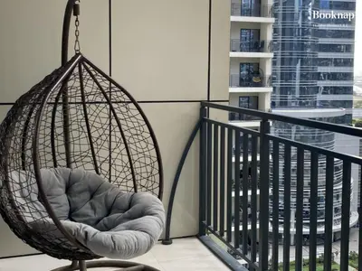 a swing chair sitting on a balcony at Luxury Stay at Zada Tower 1BHK in Business Bay in Dubai