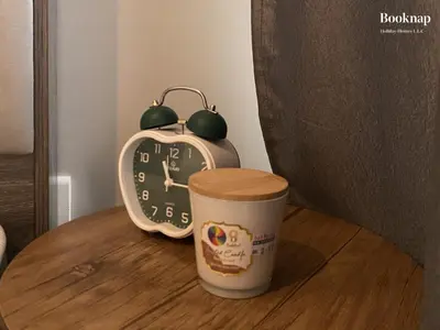 a cup of coffee and an alarm clock next to a cup of coffee at Luxury Stay at Zada Tower 1BHK in Business Bay in Dubai