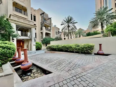 a courtyard of a building with plants and a fountain at Downtown close to Dubai mall in Dubai