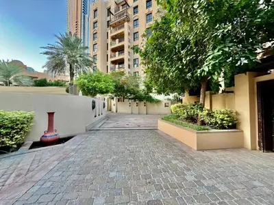 a cobblestone street in a city with trees and buildings at Downtown close to Dubai mall in Dubai