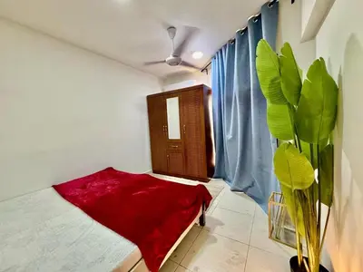 a room with a red rug and a window at Al Khaleej Apartments Karama in Dubai