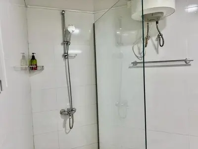 a shower with a glass door in a bathroom at Al Khaleej Apartments Karama in Dubai