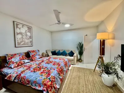 a bedroom with a bed and a couch at Al Khaleej Apartments Karama in Dubai