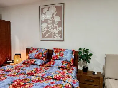 a bedroom with a bed and a picture on the wall at Al Khaleej Apartments Karama in Dubai