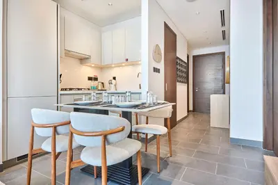 a kitchen with a counter and two stools at STAY BY LATINEM Luxury 1BR Holiday Home CB 3813 Near Burj Khalifa in Dubai