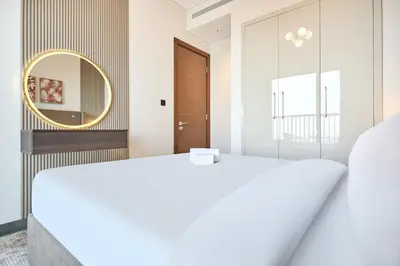 a bedroom with two beds and a mirror at STAY BY LATINEM Luxury 1BR Holiday Home CB 3813 Near Burj Khalifa in Dubai