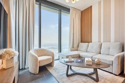 a living room with a couch and a chair and a table at STAY BY LATINEM Luxury 1BR Holiday Home CB 3813 Near Burj Khalifa in Dubai