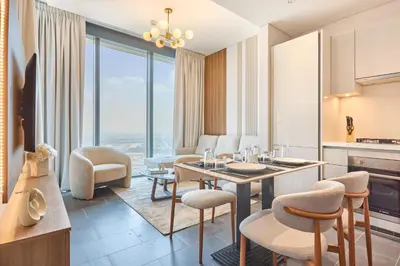 a kitchen and living room with a table and chairs at STAY BY LATINEM Luxury 1BR Holiday Home CB 3813 Near Burj Khalifa in Dubai
